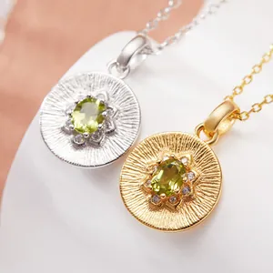Macro view of S925 sterling silver and gold-plated sunburst pendants with green gemstones