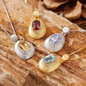 Detail of S925 silver pendants with multi-color gemstones and brushed texture finish.