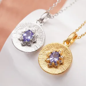 Close-up of sterling silver tanzanite medallion necklaces in gold and silver finish
