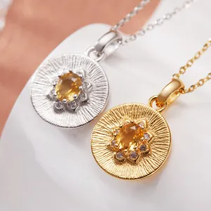 Detailed close-up of S925 sterling silver necklace pendants featuring oval yellow gemstones