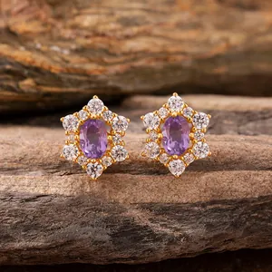 Close-up of s925 silver flower earrings with oval purple gemstones on rustic wood
