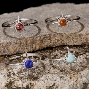 Close-up view of four S925 silver sun rings with various natural gemstones.