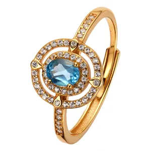 Eleganter 18K vergoldeter S925 Silberring mit ovalem blauem Topas und glitzerndem Halo