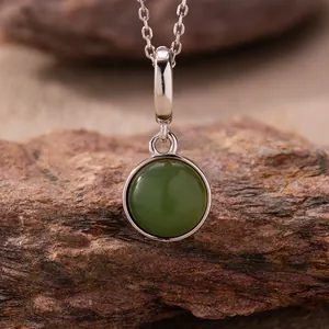 Exquisite macro detail of a natural green jasper pendant on a 925 sterling silver chain