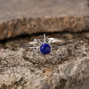 Detailed view of the blue lapis lazuli stone and sterling silver sunburst ring on stone