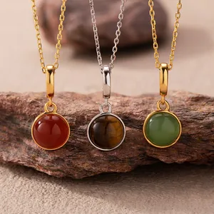 Macro detail of round gemstone pendants featuring red agate, tiger eye, and green jasper