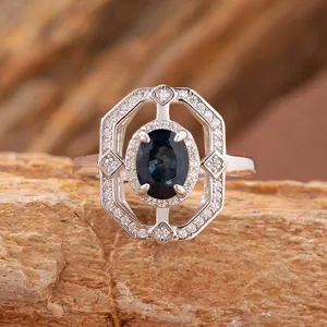 Vista macro di un anello geometrico in argento S925 con zaffiro blu scuro ovale.