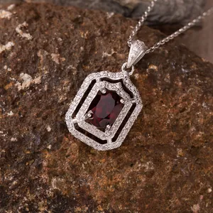 Macro shot of a vintage geometric S925 silver pendant necklace with red gemstone