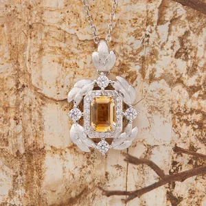 Close-up of S925 sterling silver pendant with emerald-cut natural gemstone and feather motif