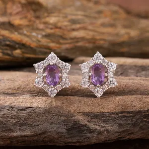 Macro view of s925 sterling silver sunflower earrings with purple gemstone centers