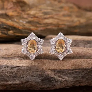 Close-up of elegant S925 sterling silver floral stud earrings with yellow gemstones