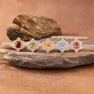 Macro detail of sunflower pendants with various natural colored gemstones in 925 silver.