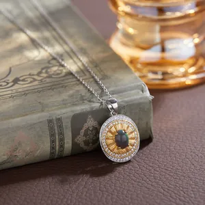 Close-up of vintage S925 sterling silver necklace with oval gemstone and sunburst pendant.