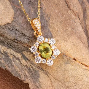Macro view of gold-plated S925 silver sunflower pendant with oval green garnet stone