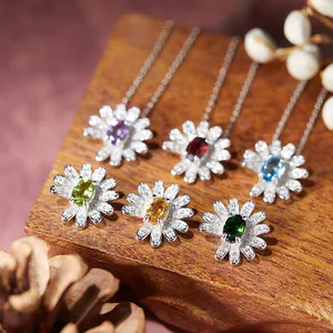 Macro detail of S925 silver daisy earrings with multi-colored natural gemstones.