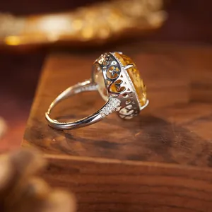 Side detail of S925 silver ring with large oval millennium cut yellow citrine.