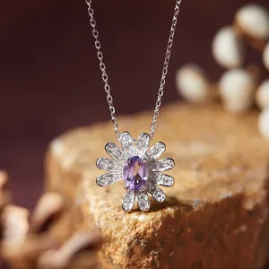 Detailed view of a silver daisy pendant necklace featuring an oval purple amethyst gemstone
