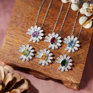Macro detail of S925 silver daisy necklaces and earrings with colored gemstones