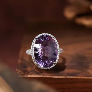 Detailed view of a luxury oval-cut purple amethyst ring with a sparkling halo setting