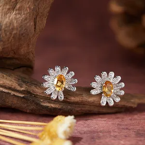 Nahaufnahme der S925 Silber Gänseblümchen-Ohrringe mit gelbem ovalen Edelstein