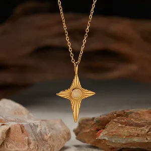 Close-up of gold star pendant necklace with a round natural opal gemstone center.