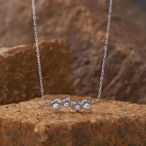 Exquisite close-up of S925 silver necklace with pearls resting on a natural stone