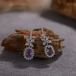 Détail de boucles d'oreilles en argent avec améthyste violette et halo de cristaux
