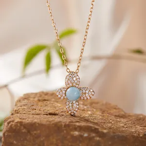 Close-up of S925 rose gold necklace with four-leaf clover larimar pendant.
