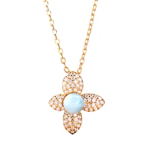 Detailed macro shot of rose gold silver necklace featuring a blue larimar clover pendant