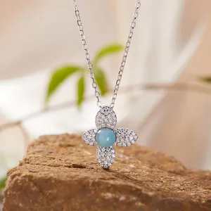 Detailed view of a S925 sterling silver necklace featuring a light blue stone flower pendant