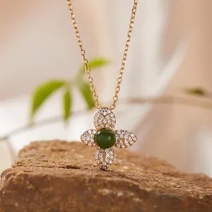 Close-up of S925 sterling silver necklace featuring a four-leaf flower jasper pendant