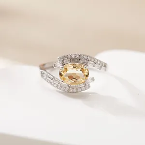Detailed close-up view of S925 silver ring with oval yellow citrine and baguette gems