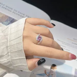 Detail of elegant S925 sterling silver ring with oval purple amethyst on hand