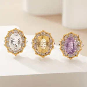 Detailed view of Victorian style oval gemstone rings with intricate gold double halos