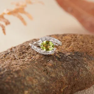 S925 sterling silver ring featuring an oval yellowish-green gemstone and zircon accents