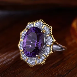 Macro view of a Victorian-style silver ring with oval amethyst and double CZ halo detail