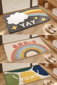 Detail view of three colorful tufted non-slip bath mats with rainbow and home patterns