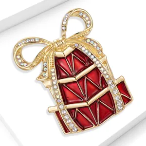 Detailed macro shot of a red enamel Christmas gift box brooch with sparkling rhinestones.
