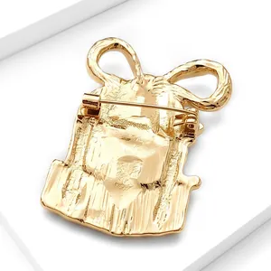 Detailed back view of gold Christmas gift box brooch featuring secure pin closure