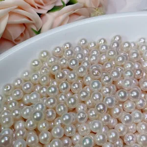 Detailed macro view of lustrous white round freshwater pearl beads for jewelry making