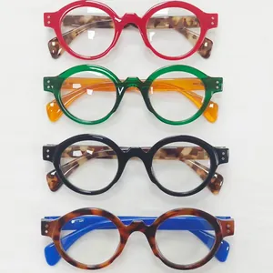 Set of four vintage round-frame reading glasses in various vibrant color combinations