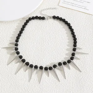 Detail view of a Gothic black bead necklace featuring silver metallic spikes on a white background.