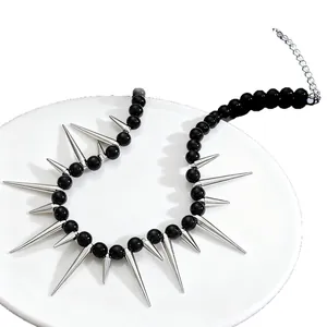 Close-up detail of gothic punk necklace with black beads and silver metal spikes