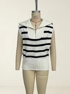 Close-up of women's black and white striped knit vest featuring a trendy half-zip collar design