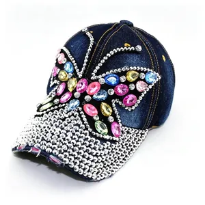 Detailed view of colorful butterfly rhinestone and distressed denim on baseball cap