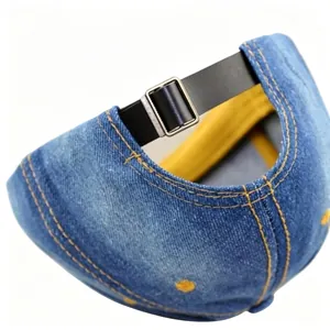 Detail view of denim baseball cap with adjustable black leather strap and metal buckle