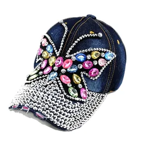 Distressed denim baseball cap with colorful rhinestone butterfly and silver studded brim