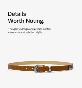 Close-up view of a vintage brown leather belt for women with an aged silver metal buckle