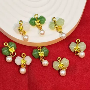 Detailed view of alloy electroplated bowknot pendants with imitation jade and pearls