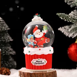 Festive Christmas snow globe music box with Santa Claus inside a red cupcake base
